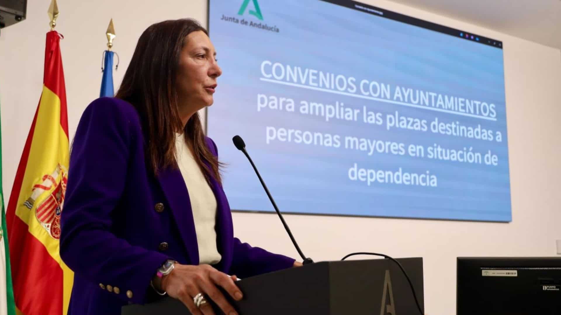 Imagen de una mujer en una rueda de prensa sobre nuevas plazas para mayores en Córdoba.