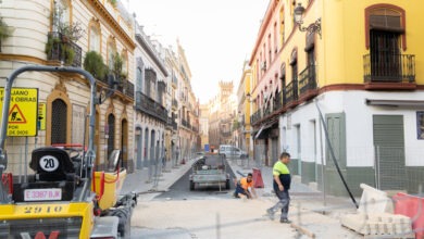 Obras de pavimentación y mejora urbana en una calle histórica de Andalucía con operarios trabajando.